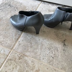 Grey leather four inch plate form heals worn once zippered on sides